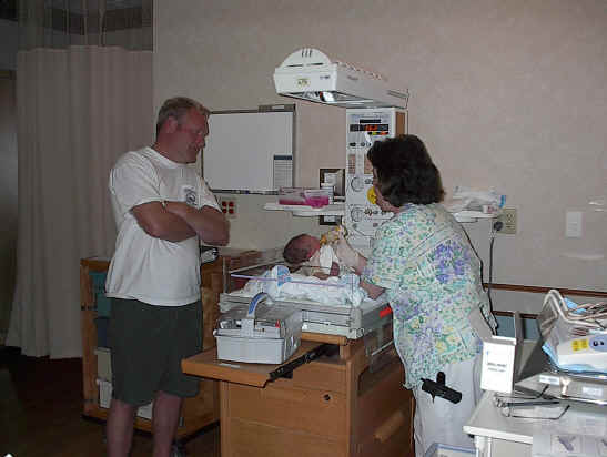Grandpa watching the nurse feeding the grandson...
